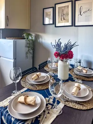 a table with plates and wine glasses on it at Brand New Scotland home 3rooms near Glasgow in Clydebank
