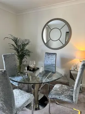 a glass table with two chairs and a mirror at 3 double bedroom spacious flat in Largs