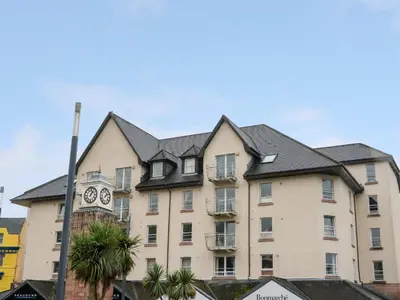 a building with a clock on the side of it at Seaview Lismore House in Oban