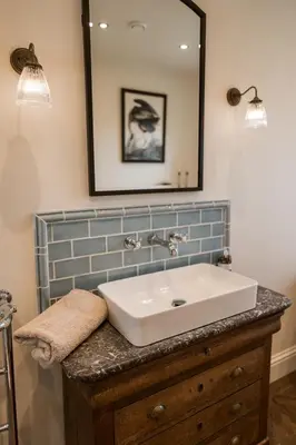 a bathroom with a sink and a mirror at Rosebank Cottage - Hot Tub & Log Stove in Alexandria