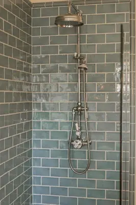 a shower in a bathroom with a blue tile wall at Rosebank Cottage - Hot Tub & Log Stove in Alexandria