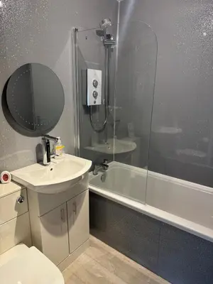 a bathroom with a sink and a shower and a tub at Loch Lomond Riverside Apartments B in Balloch
