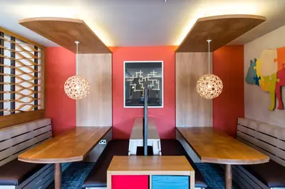 a dining room with two benches and red walls at Queen of the Loch, Balloch by Marston's Inns in Balloch
