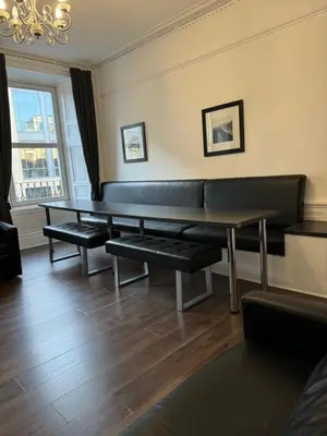 a waiting room with a bench and a table at Central Morrison Street Apartment in Edinburgh