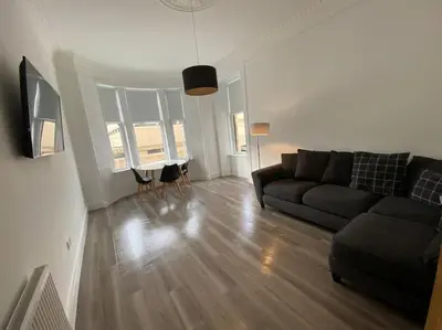a living room with a couch and a table at 4 Smithhills Central 2 bed sleeps 4 in Paisley