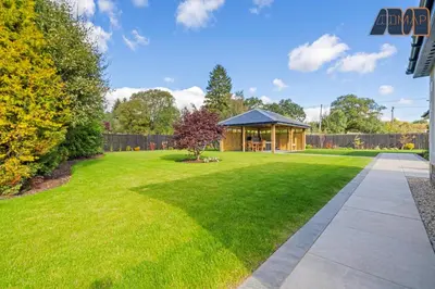 a lawn with a gazebo in a yard at Large Family Home with Hot Tub or Jacuzzi, Log Burner in Bearsden