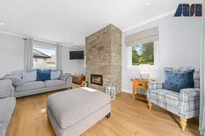 a living room with two couches and a fireplace at Large Family Home with Hot Tub or Jacuzzi, Log Burner in Bearsden