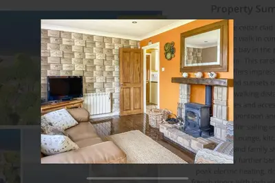 a living room with a couch and a fireplace at Picturesque beauty of Strachur in Strachur