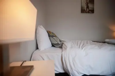 a white bed with two pillows on top of it at A stunning And Slick Escape in Stonehouse