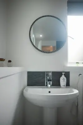 a bathroom with a white sink and a mirror at A stunning And Slick Escape in Stonehouse