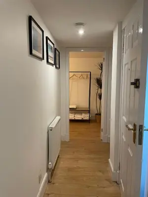 a hallway with a hallway leading to a room with a mirror at Largs 2 bedroom Apartment in Largs