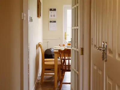 a dining room with a table and a table and chairs at Cairnies - Uk47886 in Keilour