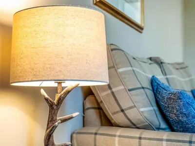 a lamp sitting next to a couch at Langside - Uk47885 in Keilour