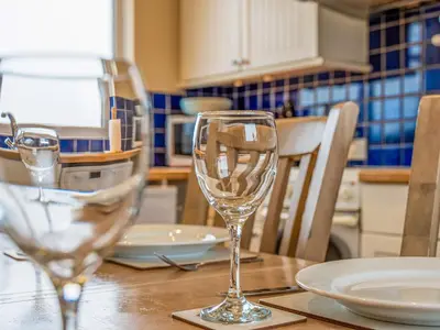 a table with two wine glasses on top of it at Langside - Uk47885 in Keilour