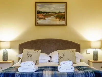 a bedroom with a bed with towels on it at Langside - Uk47885 in Keilour