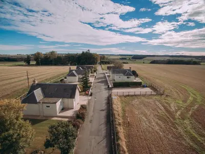 an aerial view of a farm with houses and a field at Lochy - Uk47884 in Keilour