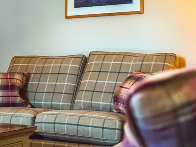 a living room with a plaid couch and a table at Lochy - Uk47884 in Keilour