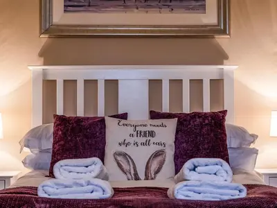 a bed with purple pillows and a picture on the wall at Lochy - Uk47884 in Keilour