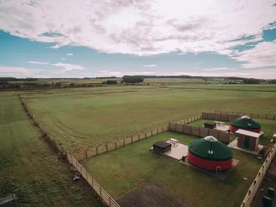 an aerial view of a large green field with tents at Timothy Yurt - Uk47889 in Keilour