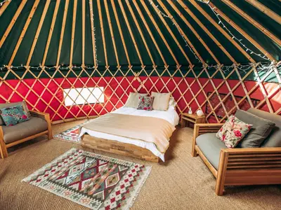 a room with a bed and two chairs in a yurt at Timothy Yurt - Uk47889 in Keilour