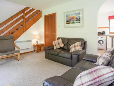a living room with a couch and a chair at Aonach Cottage - Uk41932 in Glencoe