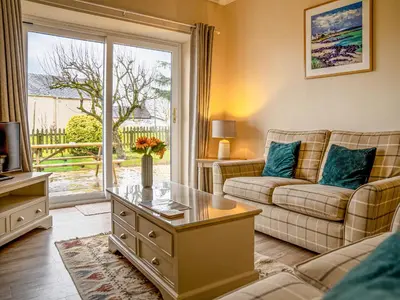 a living room with a couch and a table at Dovecote - Uk47887 in Keilour