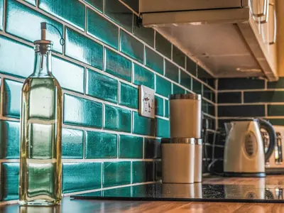 a bottle of wine on a counter in a kitchen at Dovecote - Uk47887 in Keilour