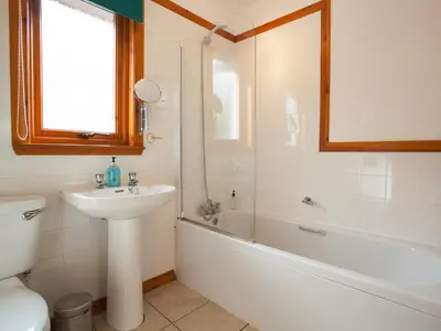 a bathroom with a sink and a tub and a toilet at Bidean Cottage - Uk41933 in Glencoe