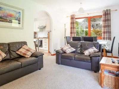 a living room with two leather couches and a table at Bidean Cottage - Uk41933 in Glencoe