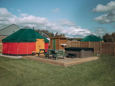 a picnic table and a tent in a yard at Moss Yurt - Uk47888 in Keilour