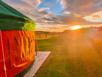 a view of the sunset from the inside of a tent at Moss Yurt - Uk47888 in Keilour