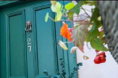a green door with the number two on it at Number Twenty Seven luxury apartment, Aberdour, Fife in Aberdour