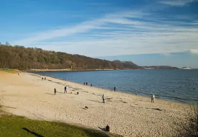 a group of people on a beach near the water at Number Twenty Seven luxury apartment, Aberdour, Fife in Aberdour
