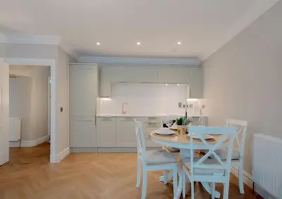 a kitchen and dining room with a table and chairs at Number Twenty Seven luxury apartment, Aberdour, Fife in Aberdour