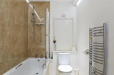 a bathroom with a tub and a toilet and a shower at Crieff Armoury in Crieff