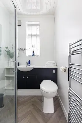 a white bathroom with a toilet and a sink at The Paddock at Brickrow Farm in Ayr