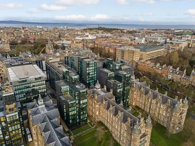 an aerial view of a city with tall buildings at Executive Quartermile apartment near to Castle University with park view in Edinburgh