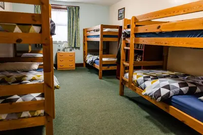 a room with several bunk beds in a room at Lochranza Centre CIC in Lochranza
