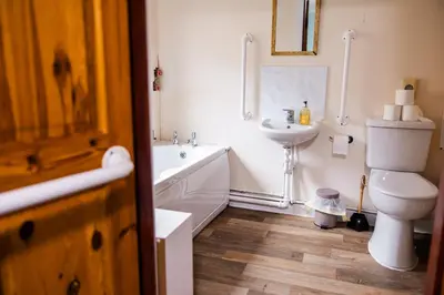 a bathroom with a tub and a toilet and a sink at Lochranza Centre CIC in Lochranza