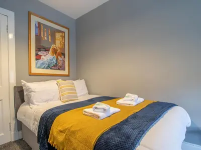 a bedroom with a bed with towels on it at The Blue Nile Hillhead - Pass the Keys in Glasgow