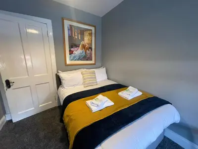 a bedroom with a bed with two towels on it at The Blue Nile Hillhead - Pass the Keys in Glasgow