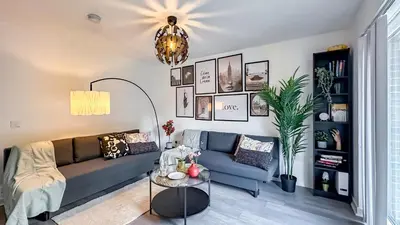 a living room with a couch and a table at Newbuild Riverview 3BDR House near Glasgow in Dalmuir