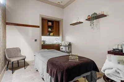 a bedroom with a bed and a sink in a room at Ugadale Cottages in Machrihanish