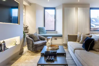 a living room with a couch and a table at Arran Shores Luxury Shorefront Apartment 2 in Lamlash