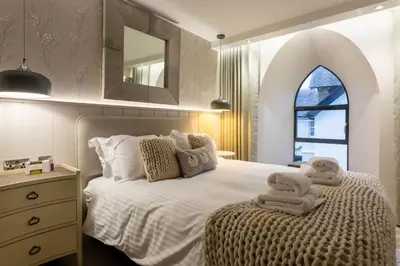 a bedroom with a bed with towels on it at Arran Shores Luxury Shorefront Apartment 3 in Lamlash