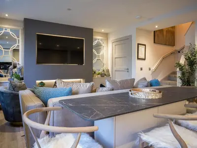 a kitchen and living room with a table and chairs at Arran Shores Luxury Shorefront Apartment 3 in Lamlash