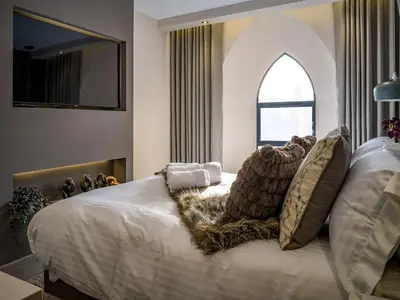 a bedroom with a white bed with pillows and a window at Arran Shores Luxury Shorefront Apartment 4 in Lamlash