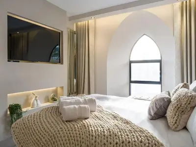 a bedroom with a large white bed with a large window at Arran Shores Luxury Shorefront Apartment 4 in Lamlash