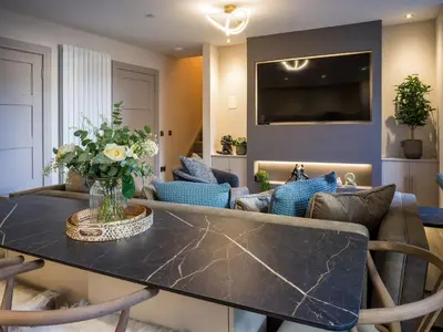 a living room with a table and a couch at Arran Shores Luxury Shorefront Apartment 5 in Lamlash