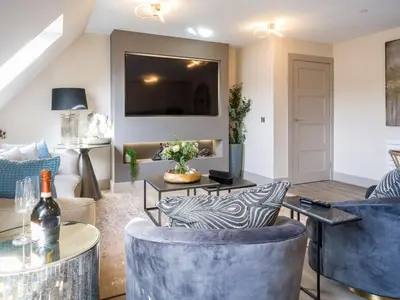 a living room with a couch and a tv at Arran Shores Luxury Shorefront Apartment 14 in Lamlash